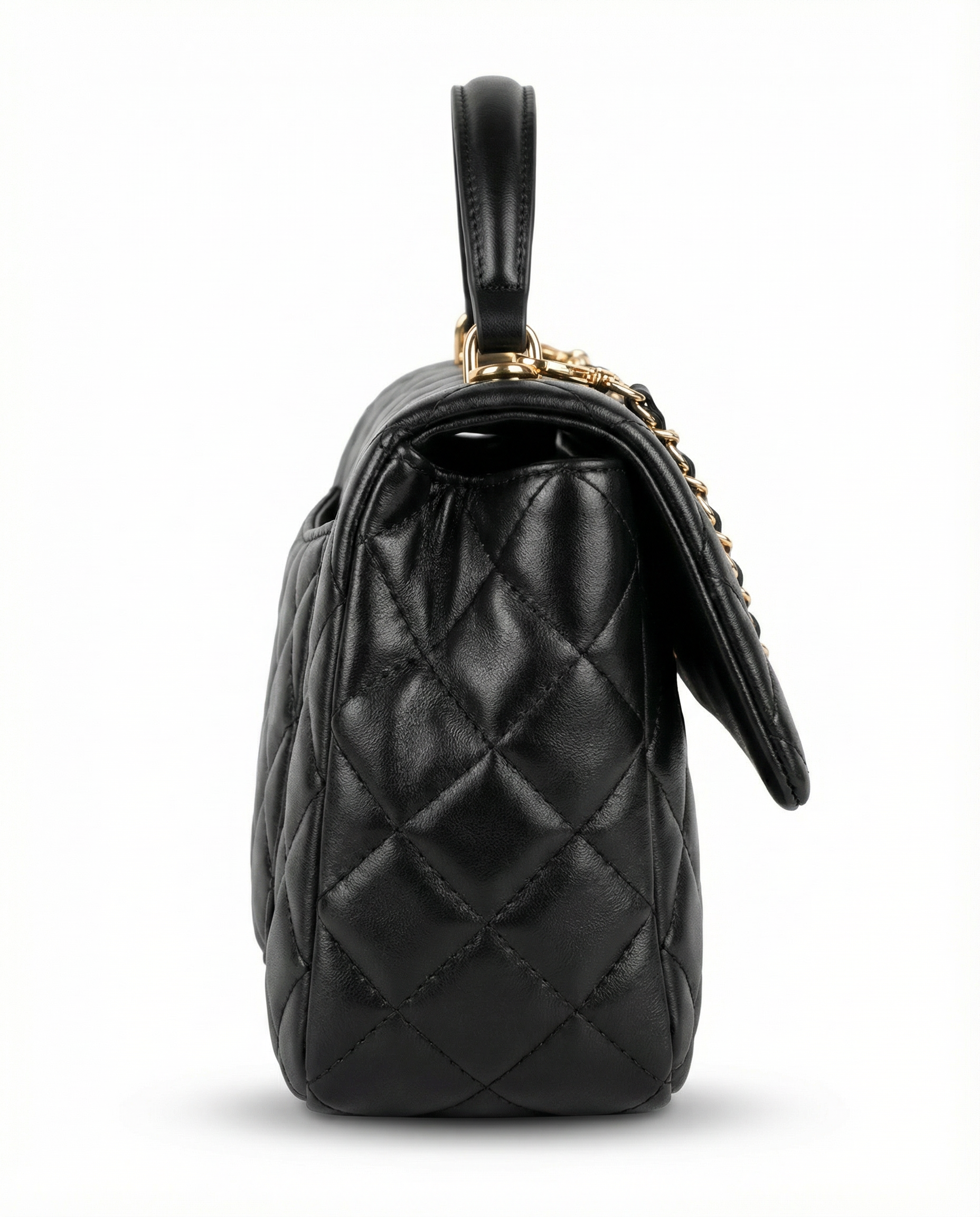 Side profile of black quilted ChristAdorn handbag with structured silhouette and gold hardware.
