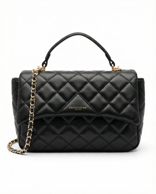 Black quilted ChristAdorn handbag in vegan leather with gold chain strap and top handle on white background.