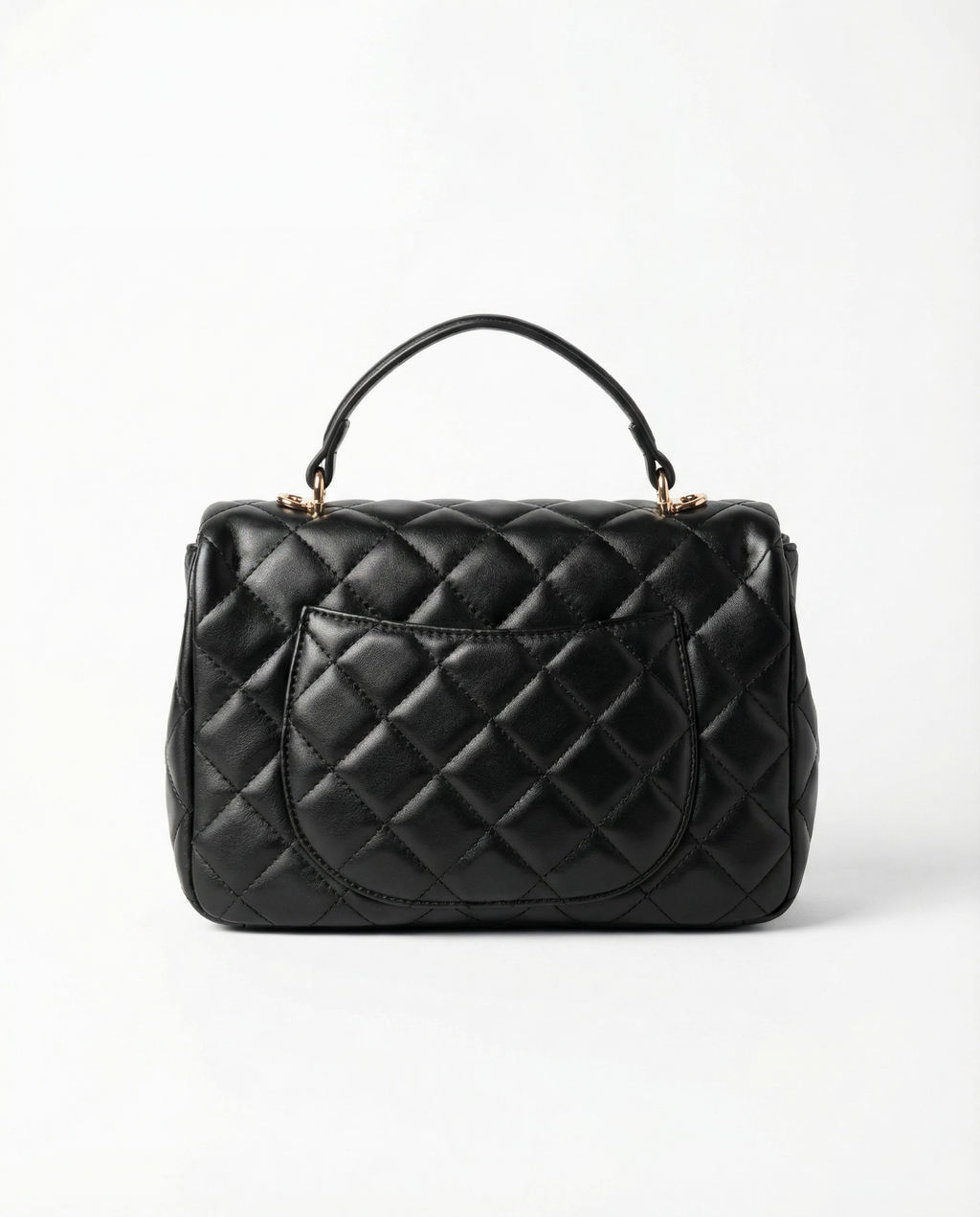 Back view of black quilted ChristAdorn handbag with rear slip pocket and top handle.